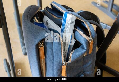 Hildesheim, Deutschland. April 2021. In einem Klassenzimmer der Robert Bosch Comprehensive School in Hildesheim ragt ein Corona-Selbsttest aus der Tasche eines Schülers. Der Start der obligatorischen Corona-Selbsttests für Schüler und Lehrer war aus Sicht des Niedersächsischen Schulmanagements chaotisch. Quelle: Julian Stratenschulte/dpa/Alamy Live News Stockfoto