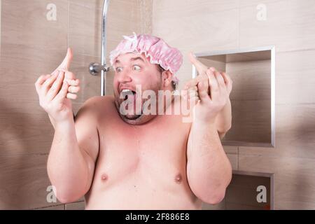 Komischer fetter Mann singt unter der Dusche. Stockfoto