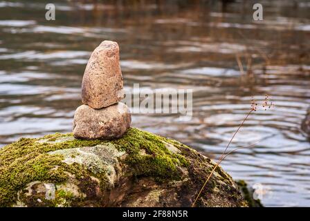 Eine ruhige, ruhige, winterliche HDR-Aufnahme aus dem Jahr 3 mit gestapelten Steinen auf einem Felsbrocken in Loch Voil in der Nähe von Balquhidder, Perthshire, Schottland. 22. Dezember 2008 Stockfoto