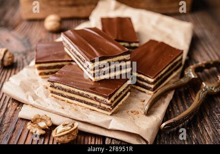 Köstlicher Kakao- und Walnusskuchen mit Pflaumenmarmelade, gekrönt mit Schokoladenfrosting Stockfoto