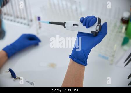 Qualifizierter Biochemiker, der ein Laborgerät für einen Bluttest verwendet Stockfoto