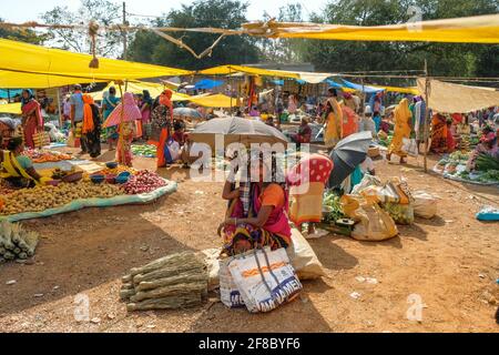 Bastar, Indien - 2021. März: Adivasi-Frauen verkaufen Besen auf dem Wochenmarkt in Bastar am 4. März 2021 in Chhattisgarh, Indien. Stockfoto