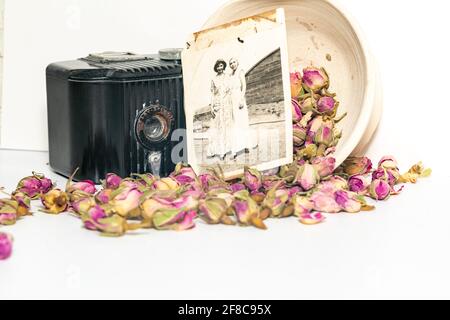 Alte Erinnerungen, Omas alte Baby-Brownie-Kamera, alte Fotos und das Stillleben getrockneter Rosen Stockfoto