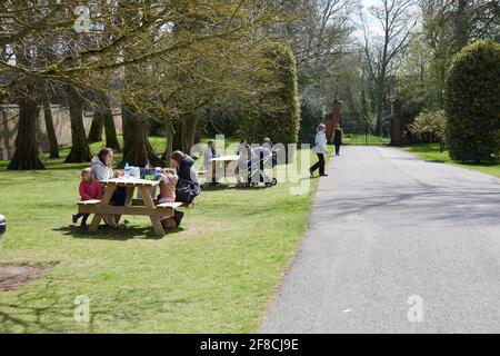 Familien und Menschen, die nach dem Ende der Sperre in England, Großbritannien, während der kovid19-Pandemie Essen im Freien genießen Stockfoto