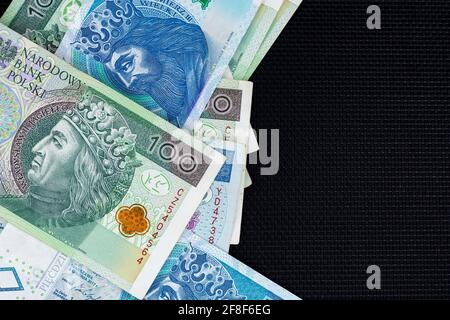 Polnische Banknoten von 100 PLN und 50 PLN auf schwarzem Hintergrund. Foto aufgenommen unter weichem Kunstlicht Stockfoto