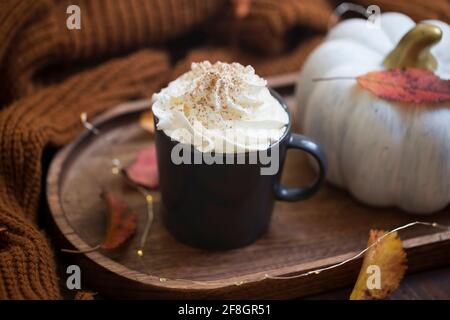 Herbstlicher Kürbis-Latte mit Schlagsahne, saisonaler Herbst-Kürbis-Kaffeebecher mit Herbstdekor Stockfoto