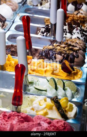 Italienisches Eis. Tabletts mit verschiedenen Geschmacksrichtungen von italienischem Gelato. Behälter mit Eiscreme in verschiedenen Farben. Stockfoto