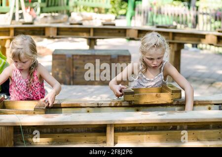 Liebenswert kleine blonde Mädchen Goldwaschen und versuchen, eine zu finden Gold Stockfoto