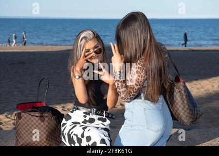 Edinburgh, Schottland, Großbritannien. April 2021. IM BILD: Leute, die sich am Portobello Beach Vergnügen. Die Menschen genießen den klaren blauen Himmel und das warme, sonnige Wetter auf der Ostseite Schottlands am Portobello Beach. Quelle: Colin Fisher/Alamy Live News Stockfoto