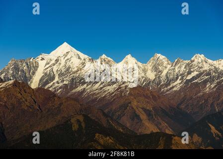 Blick auf die schneegedeckten Panchuli-Gipfel fällt in den großen Himalaya Bergkette & alpine Graswiesen auf dem Weg nach Khalia Top trekk Trail bei Small hamle Stockfoto