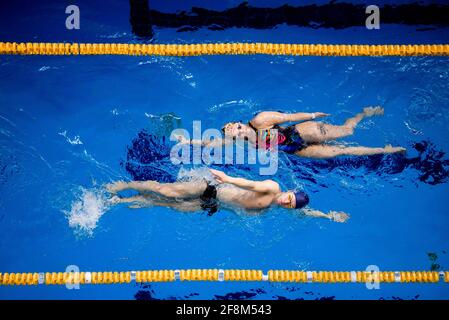 Ausbildung von professionellen Schwimmern. Sportler schwimmen auf dem Rücken im Pool. Stockfoto