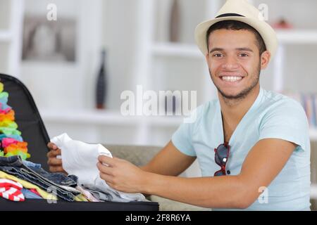 Der Mensch seine grauen Koffer im Wohnzimmer Stockfoto