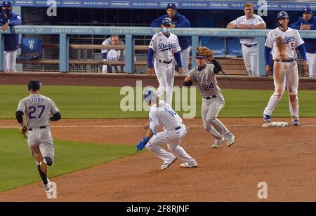 Los Angeles, Usa. April 2021. Der dritte Baseman von Los Angeles Dodgers, Justin Turner, wird am Mittwoch, den 14. April 2021, im Dodger Stadium in Los Angeles beim siebten Inning mit dem Shortstop der Colorado Rockies, Trevor Story (27) und dem zweiten Baseman, Ryan McMahon (24), erwischt. Die Dodgers besiegten die Rockies 4-2 Foto von Jim Ruymen/UPI Quelle: UPI/Alamy Live News Stockfoto