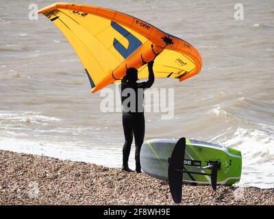 Sheerness, Kent, Großbritannien. April 2021. UK Wetter: Sonnig in Sheerness, Kent. Ein Mann versucht die neue Sportart der Tragflügeldrachen oder des "Flügelsurfens" oder "Flügelfolierung" - ein Hydrofoil-Board mit einem kleinen Drachen, den man direkt hält - anstatt die Kontrolle über mehrere Saiten und ein Geschirr wie beim traditionellen Kitesurfen zu haben. Kredit: James Bell/Alamy Live Nachrichten Stockfoto