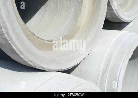 Industriebetonentwässerungsrohre für den Bau gestapelt. Neue Röhrchen. Stockfoto