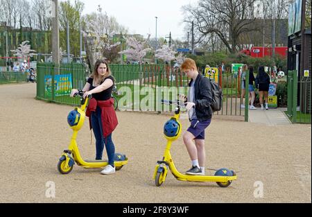 Junges Paar mit gemieteten Elektrorollern. Stockfoto