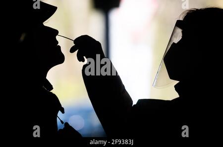 Hannover, Deutschland. April 2021. Helfer testen eine Frau im Testzentrum am Zoo mit einem Schnelltest auf das neuartige Corona-Virus. Das Robert Koch-Institut (RKI) berichtet weiterhin über einen Anstieg der neuen Coronainfektionen in Deutschland. Quelle: Julian Stratenschulte/dpa/Alamy Live News Stockfoto