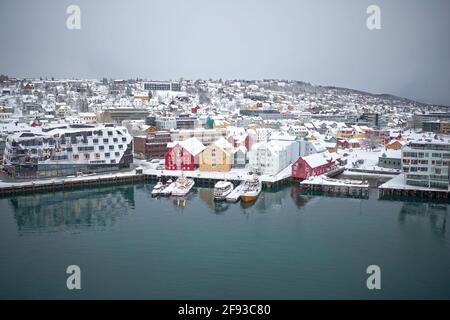 Luftdrohnenfoto von Tromso in Nordnorwegen, das die farbenfrohen Bootsschuppen entlang des Hafens zeigt. Bild aufgenommen mit DJI Mavic 2 Pro. Stockfoto