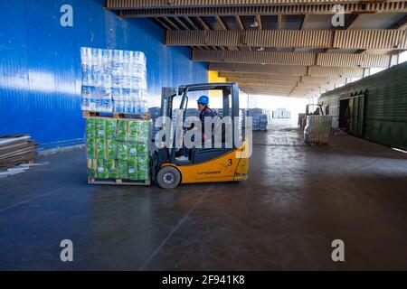 Aktoby, Kasachstan. Der Hebevorführer transportiert Toilettenpapier zum Lager. Modernes Distributionszentrum und Lager. Stockfoto