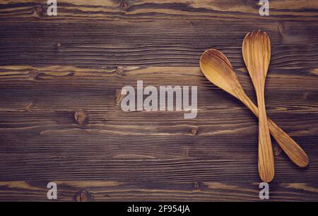 Holzlöffel auf dunklem Holzhintergrund. Draufsicht, Kopierbereich. Stockfoto