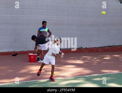 Kleine Kinder, die Tennisunterricht mit einem Trainer an der SPG (Shivaji Park Gymkhana) Tennis Academy in Mumbai, Maharashtra, Indien, haben. Stockfoto