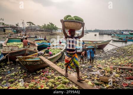 Barishal, Bangladesch. April 2021. Arbeiter entladen Wassermelonen von Booten entlang eines Flussufers in der Nähe eines Großhandelsmarktes in Barishal, Bangladesch. (Foto: Mustasinur Rahman Alvi/Pacific Press) Quelle: Pacific Press Media Production Corp./Alamy Live News Stockfoto