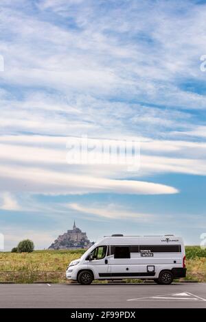 Wohnmobil / Van 'Vantourer Black and White' vor der schönen historischen Gezeiteninsel und Festung Le Mont-Saint-Michel. Das Denkmal ist ein UNESCO-Weltkulturerbe in der Normandie, Frankreich Stockfoto