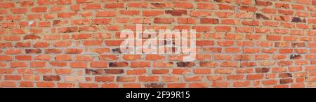Textur einer roten Ziegelwand mit Zementverbindungen. Stockfoto
