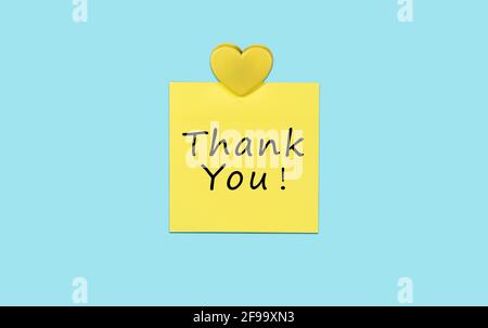 Gelbe klebrige Dankesnotiz und Herz. Stockfoto