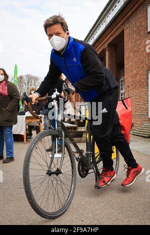 Steinbergkirche, Deutschland. April 2021. Robert Habeck, Bundesvorsitzender von Bündnis 90/die Grünen, kommt mit dem Fahrrad zu einer Mitgliederversammlung der Grünen zur Wahl des Direktkandidaten für den Bundestag. Die Grünen der Stadt Flensburg und des Landkreises Schleswig-Flensburg wollen bei der Veranstaltung in der Steinbergkirche ihren Direktkandidaten für die Bundestagswahl im September 2021 nominieren. Der einzige Kandidat ist bisher Parteiführer Habeck. Quelle: Christian Charisius/dpa/Alamy Live News Stockfoto