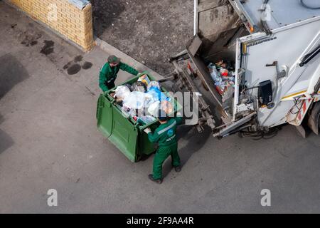 Arbeiter bei der Müllabfuhr, die Müllwagen verladen, Moskau,15.04.2021 Stockfoto