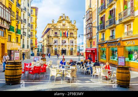 PAMPLONA, SPANIEN, 28. OKTOBER 2014: In Pamplona, Spanien, sitzen Menschen in einem Café vor dem Rathaus Stockfoto