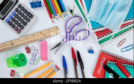 Overhead-Ansicht des Sortiments von Schulmaterial auf einem weißen Tisch. Zurück zum Schulkonzept Stockfoto