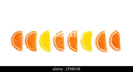 Orangefarbene und gelbe Scheiben süßer Fruchtmarmelade in Zucker isoliert auf weißem Hintergrund. Studio Photo Stockfoto