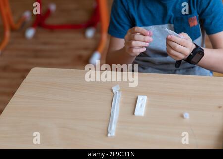 Der Junge wird vor der Klasse auf covid-19 getestet. Stockfoto