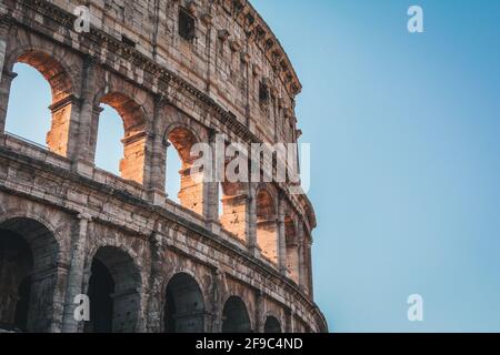 Coliseum (Kolosseum), Rom, Italien. Das antike römische Kolosseum ist ein berühmtes Wahrzeichen und eine der beliebtesten Touristenattraktionen Roms. Panoramablick auf das Kolosseum mit Bäumen und b Stockfoto