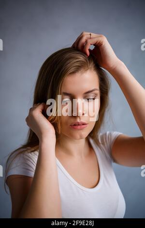 Nahaufnahme Porträt einer schönen jungen Frau. Emotionales Foto eines Mädchens. In einem weißen T-Shirt gekleidet Stockfoto