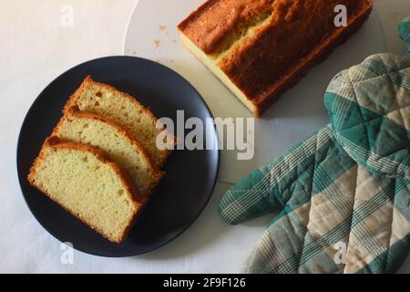 Scheiben hausgemachten Vanillekuchen. Es wird auch als gelber Kuchen oder Butterkuchen oder Teekuchen bezeichnet. Aufgenommen auf weißem Hintergrund. Stockfoto