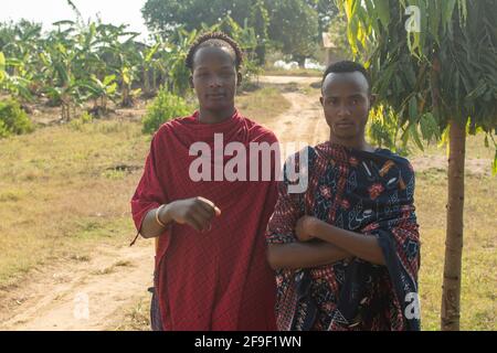 Dodoma, Tansania. 08-18-2019. Porträt zweier schwarzer junger Bauern aus der ethnischen Gruppe der maasai, die als Sicherheitsdienst für eine lokale Schule in Tansania arbeiten. Stockfoto