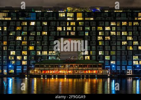 Wohngebäude mit asiatischem Restaurant in Baltimore Wharf at Night, London, England Stockfoto
