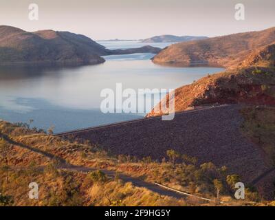 Vor der Dämmerung leuchten die Hügel über dem Lake Argyle und dem irdenen Old River Dam, Kununurra, Kimberley, Stockfoto