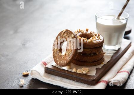 Ein Stapel von Shortbread hausgemachte Kekse mit Erdnüssen auf einem hölzernen Hintergrund mit Milch. Peanut Cookie. Stockfoto