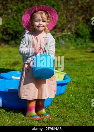 Kleinkind spielt im Garten, Großbritannien Stockfoto