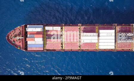 Großes Containerschiff, das mit verschiedenen Containermarken beladen ist. Stockfoto