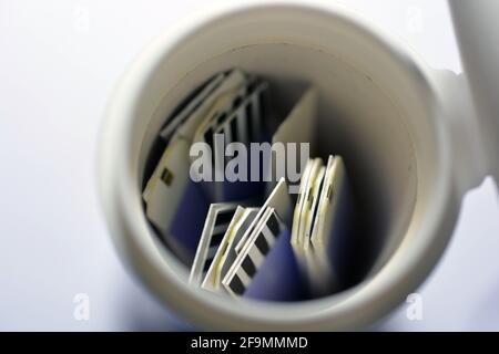 Ein kleiner Behälter mit Teststreifen für Diabetiker, der Zufallszucker-RBS (Blutzucker) in einem Glukosimeter zu Hause misst, das auf Whit isoliert ist Stockfoto