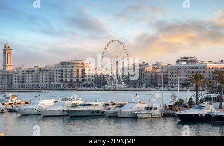 Panoramablick auf den Sonnenuntergang über dem beleuchteten Riesenrad an der Küste von Bari, Region Apulien, Italien. Apulien. Panorama Stockfoto