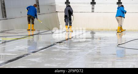 15. April 2021, Sachsen-Anhalt, Halle (Saale): Mitarbeiter der Bäder Halle GmbH reinigen das große Schwimmbad im Nordbad. Die Freibäder in Sachsen-Anhalt bereiten sich trotz der unsicheren Corona-Situation auf die kommende Saison vor. Mehrere Pools planen die Eröffnung ab dem 15. Mai unter Berücksichtigung möglicher pandemischer Veränderungen. Foto: Jan Woitas/dpa-Zentralbild/ZB Stockfoto