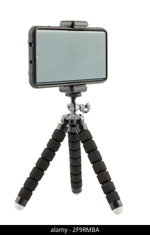Schwarzes Handy in robuster Gummischutzhülle auf kleinem flexiblen Stativ isoliert auf weißem Hintergrund Stockfoto
