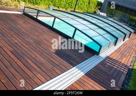 IPE Wood Pool Deck Design, wunderschöne Ipe Hartholz Terrasse um den überdachten Swimmingpool im Garten Stockfoto