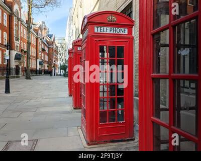 Blick auf die roten britischen Telefonzellen entlang des traditionellen Englischen Lage in London Stockfoto
